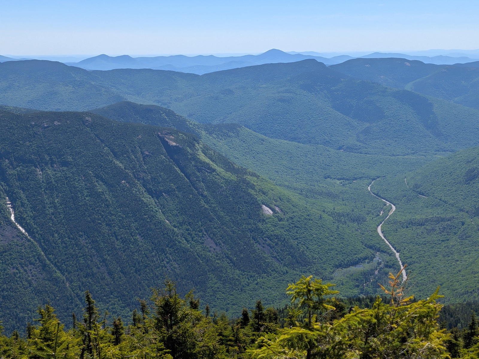 View down into a deep notch with a road winding through it