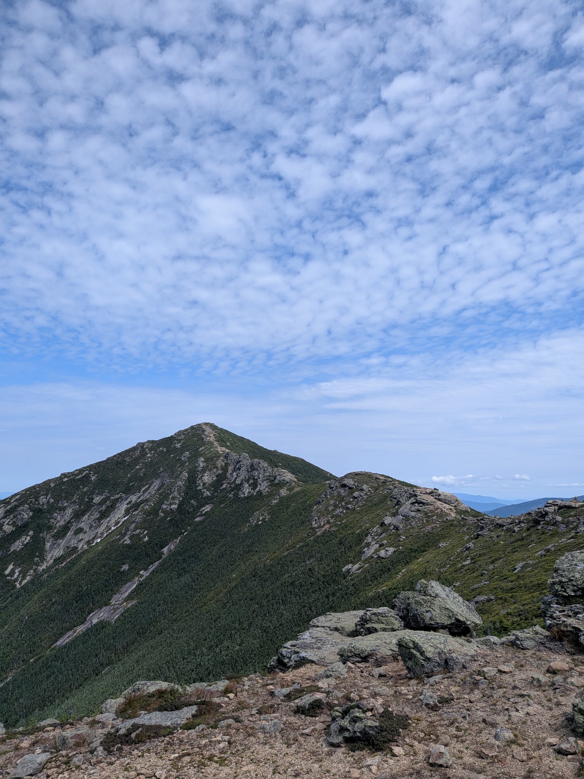 Open ridgeline running toward a pointed summit