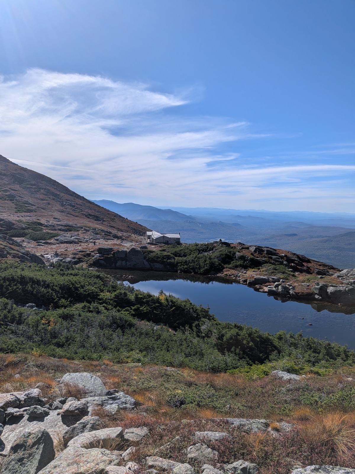 Alpine tarn with a stone hut beside it